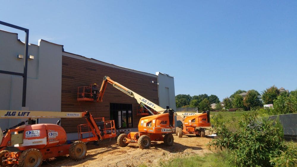 An Exterior Builder Services crew installing commercial siding